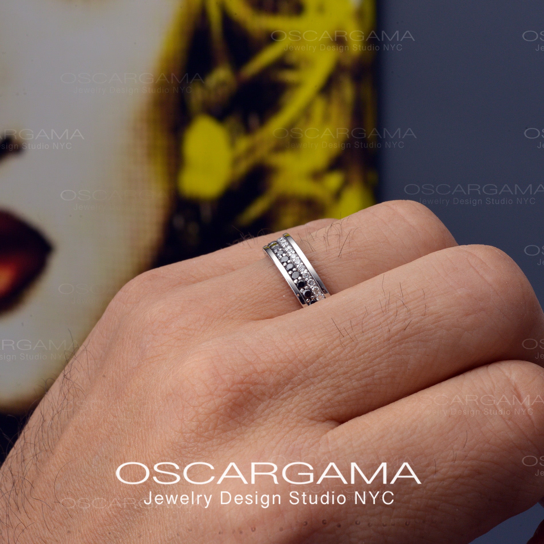 hand with man wedding band with black and white diamonds