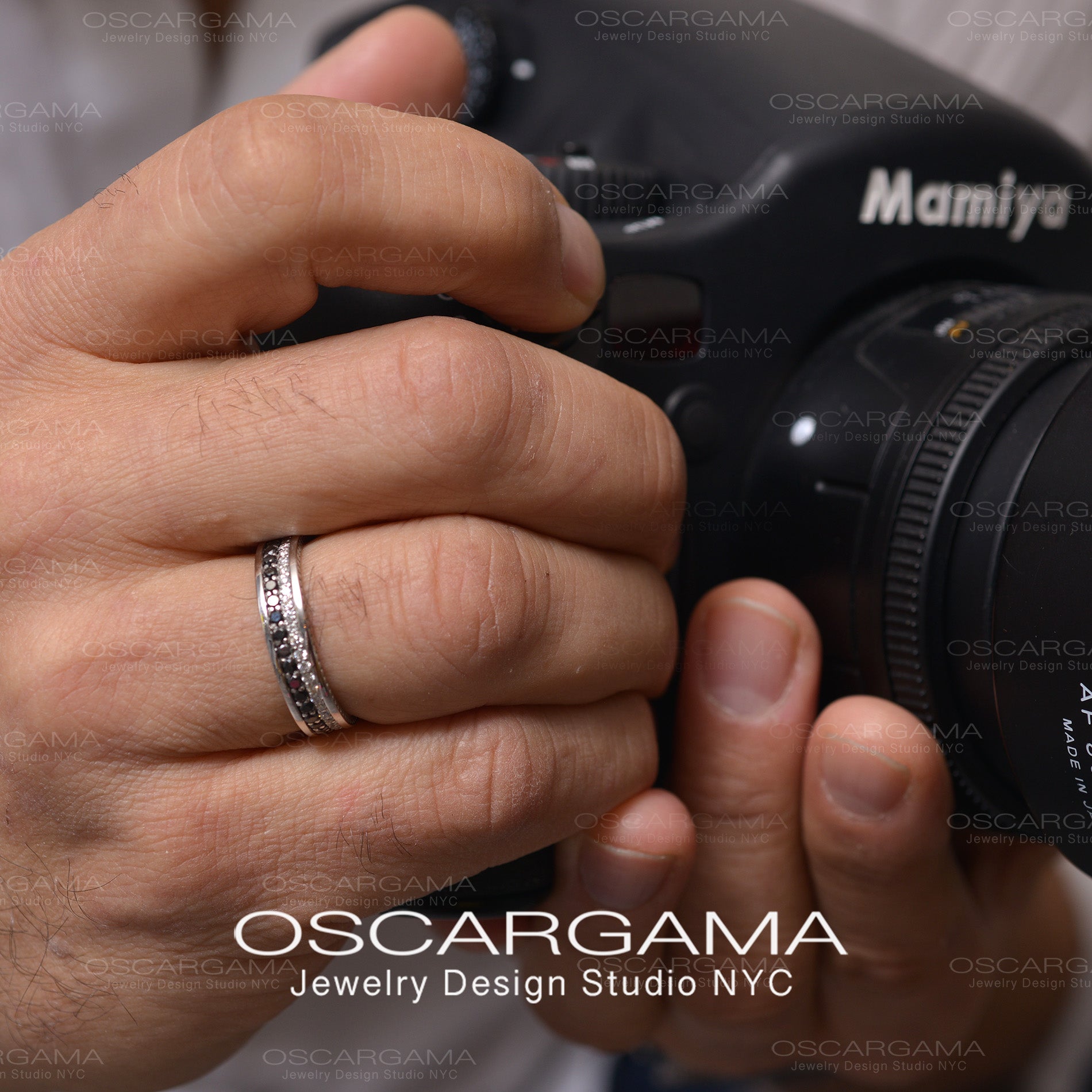 hand with man wedding band with black and white diamonds