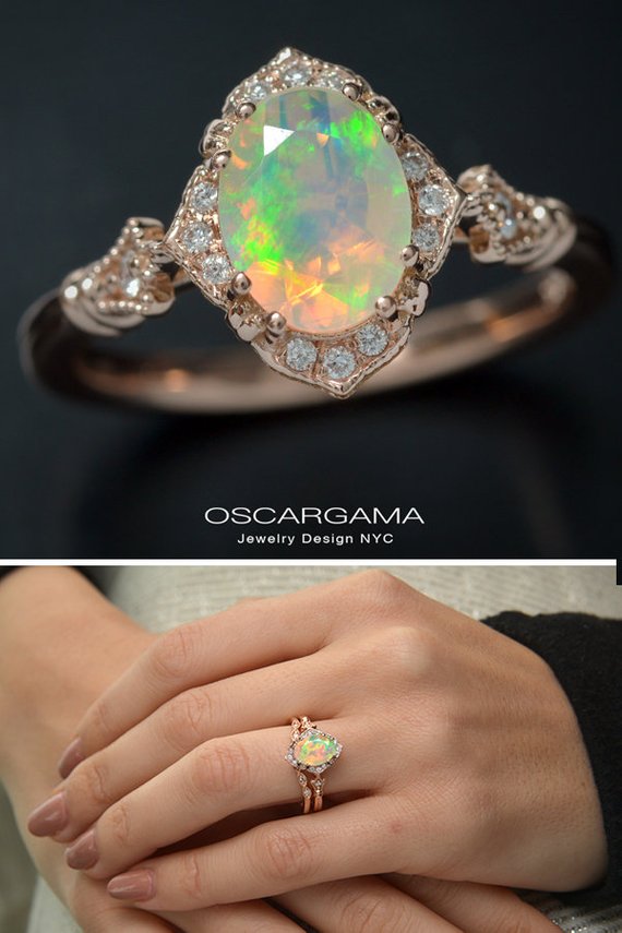 oval opal engagement ring in rose gold in a hand