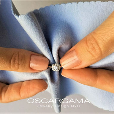 diamond engagement ring being cleaned by two hands