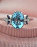 Oval blue aqua marine engagement ring with marquise sapphires