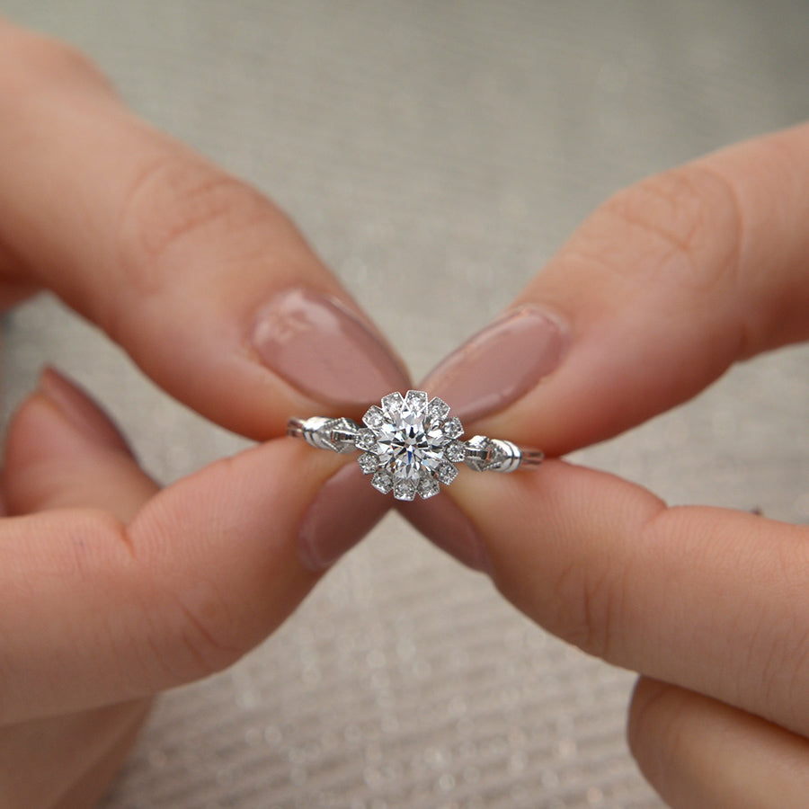 round halo vintage inspired engagement ring in rose gold model's hand