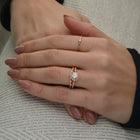 round halo vintage inspired engagement ring in rose gold model's hand