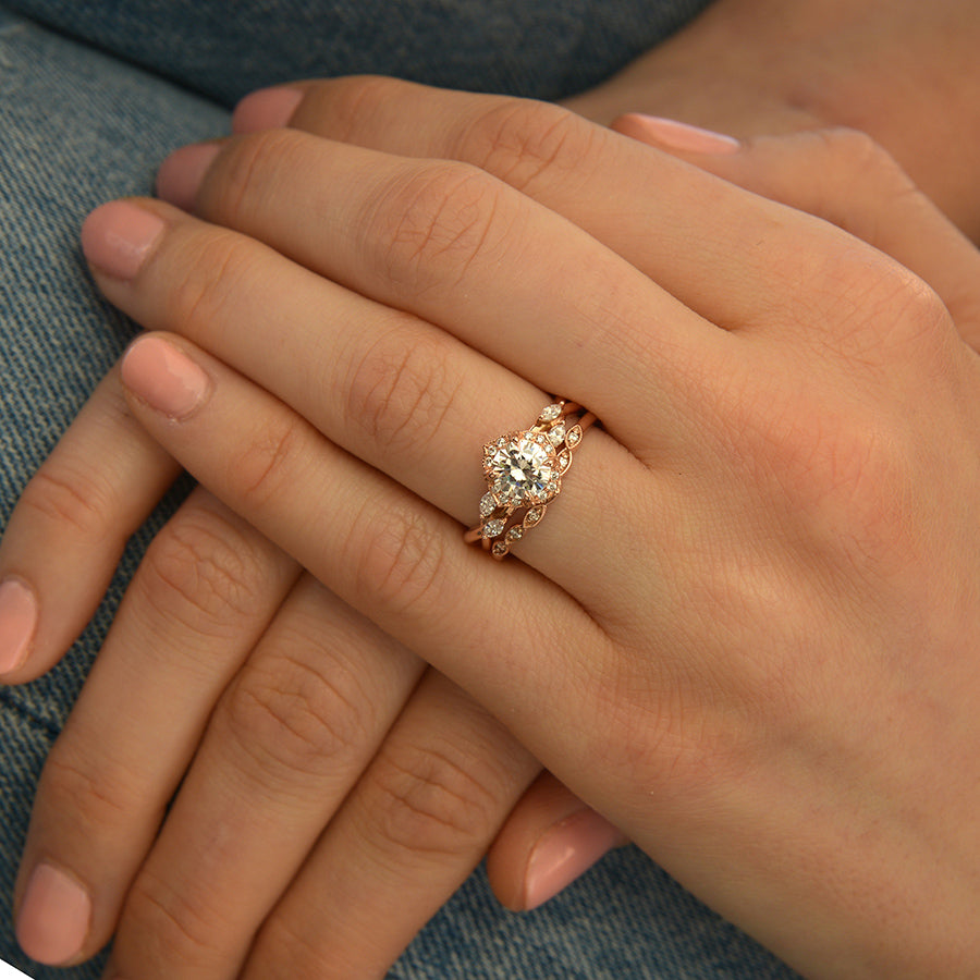 white gold Moissanite halo engagement ring twisted band on a hand