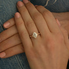 Oval Halo vintage look engagement ring in a hand