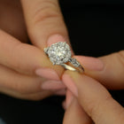 round halo vintage look engagement ring in withe gold in amodel's hand
