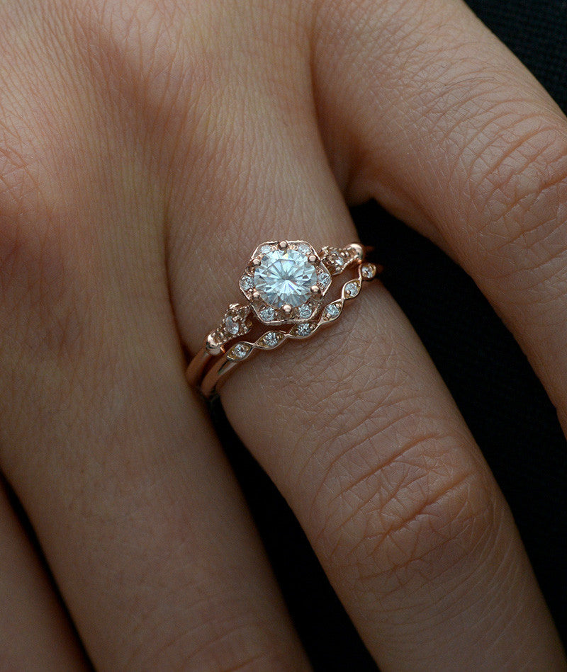 curved scalloped wedding band with 6 diamonds in a hand