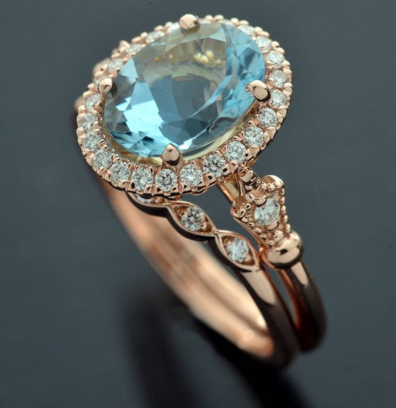 Oval aqua marine engagement ring halo in rose gold vintage inspired