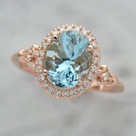 Oval aqua marine engagement ring halo in rose gold vintage inspired